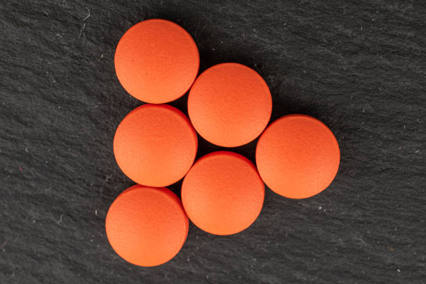 istock Orange pharmacy tablet on grey stone 1181851010