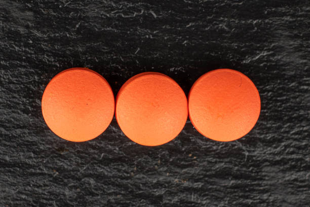 istock Orange pharmacy tablet on grey stone 1181851044