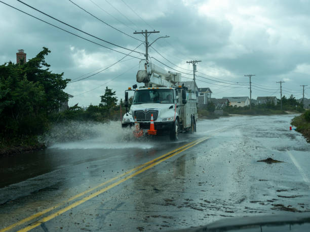Utility truck navigates flood damaged road stock photo