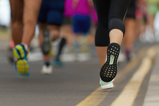 istock Marathon runners running on city road 1181853069