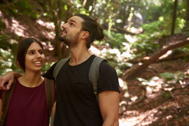 istock Young couple talking and laughing as they walk 1181853570