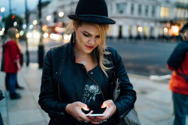 istock Student waiting at the bus stop and texting 1181855477