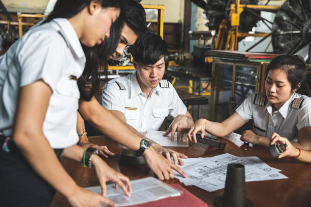 Group of Students at Aviation University during practical class Students at university in Thailand.

Note for inspectors: documents and papers are fake printed and created by myself pilot training stock pictures, royalty-free photos & images