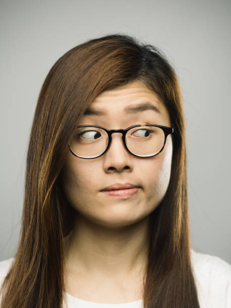 istock Real chinese young woman with blank expression looking to the side 1181861637