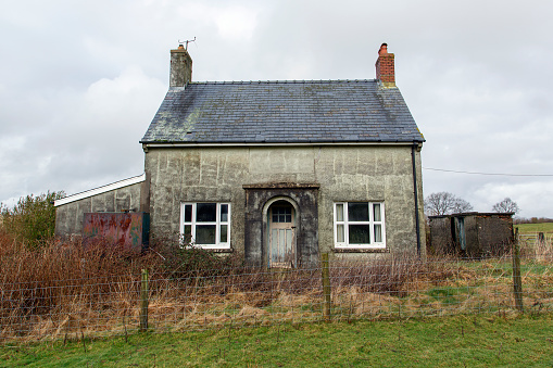 Small double fronted, abandoned cottage in a remote location in Wales.