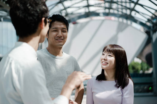 istock Three young Asian men and women enjoying conversation 1181866574