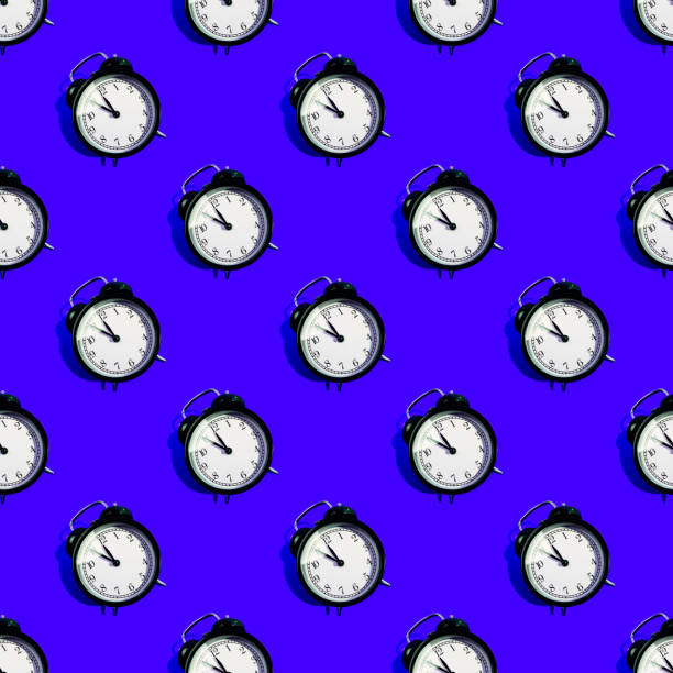 istock Many black classic style alarm clock isolated on blue background 1181867282
