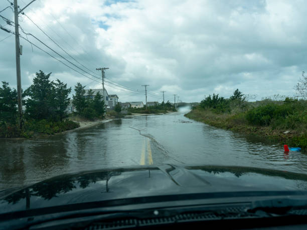 View from the diver's seat of a car driving down a flooded road after a storm stock photo