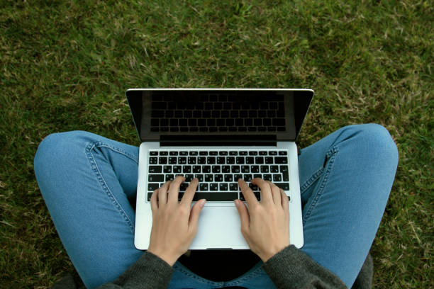 istock Close-up woman texting using her laptop 1181869038