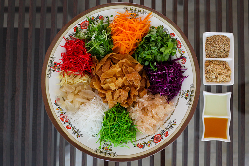 Yusheng, yee sang or yuu sahng, or Prosperity Toss, also known as lo hei is a Cantonese-style raw fish salad. It usually consists of strips of raw fish, mixed with shredded vegetables and a variety of sauces and condiments, among other ingredients. Popularly known in Malaysia and Singapore.