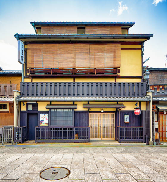 Japanese restaurant building facade exterior in daytime with sidewalk and paved street, photographed in Gion district.