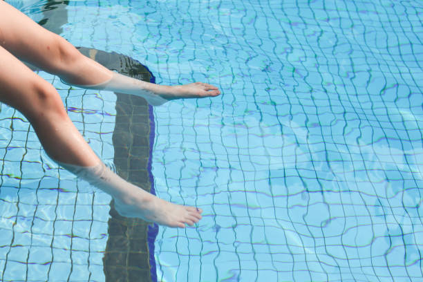 istock A Child Pair of Legs Soaking Inside a SwimmingPool 1181870861