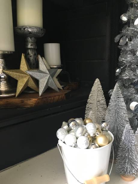 istock Silver gold and white Christmas decorations in front  of fireplace 1181873837