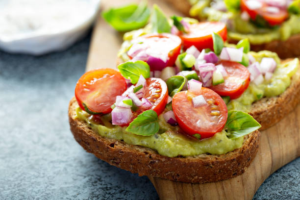 istock Fresh guacamole and tomato sandwich spread 1181873890