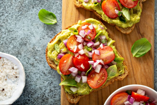 istock Fresh guacamole and tomato sandwich spread 1181873910