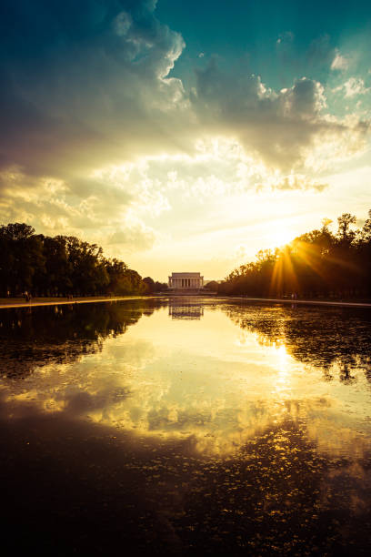 Evening image of the Lincoln Memorial with the reflecting pool lincoln memorial; abraham lincoln; memorial evening; reflecting pool; national mall; civil war; abraham; civil; confederacy; freedom; lincoln; memorial; night; president; slavery; symbol; war; washington; justice; landmark; north; pillars; south; tourism; evening; dusk; district of Columbia; washington dc; DC monuments evening; America; USA; Dawn; Morning washington dc slavery the mall lincoln memorial stock pictures, royalty-free photos & images