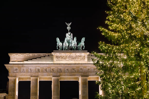 Illuminated Neoclassical Brandenburg Gate (Brandenburger Tor) and Christmas Tree as viewed from the Pariser Platz, Mitte, Berlin, Germany
