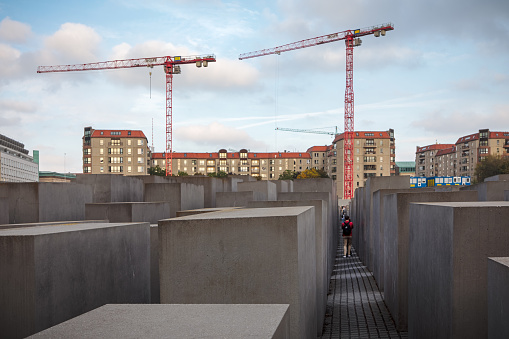 Berlin, Germany, September 24, 2019: View of Memorial to the murdered Jews of Europe in Berlin. It is also known as Holocaust Memorial. On one hand a popular tourist destination and on the other hand a memoral for on of the darkest periods of European history. The monument is designed by the architect Peter Eisenman and the engineer Buro Happold.