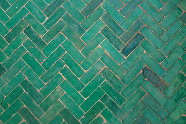 Green herringbone flooring tile texture Close up shot of green herringbone brick flooring tile herringbone stock pictures, royalty-free photos & images