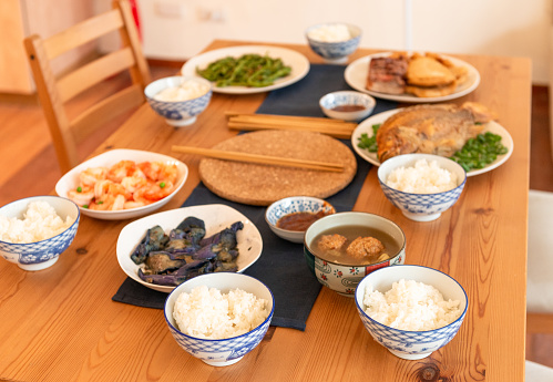 A collection of dishes ready for a traditional Chinese family meal.