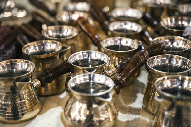 istock Turkish copper coffee pots with ornaments on a counter in a Turkish bazaar 1181876185
