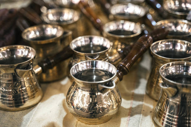 istock Turkish copper coffee pots with ornaments on a counter in a Turkish bazaar 1181876190