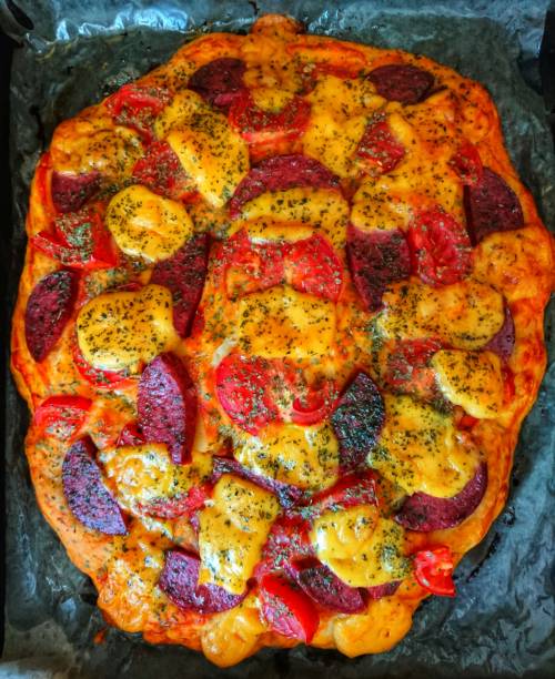 Homemade pizza made from cheese, tomatoes and sausages