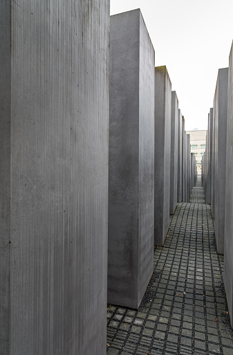 Berlin, Germany, October 5, 2019: View of Memorial to the murdered Jews of Europe in Berlin. It is also known as Holocaust Memorial. On one hand a popular tourist destination and on the other hand a memoral for on of the darkest periods of European history. The monument is designed by the architect Peter Eisenman and the engineer Buro Happold.