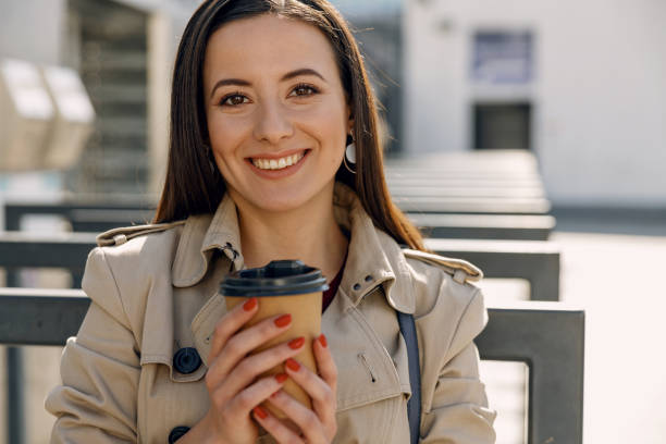 istock Charming young female holding cup in both hands 1181878752