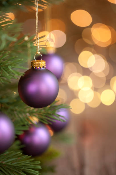 istock Christmas Tree with Purple Baubles and Gold Lights Background 1181879137