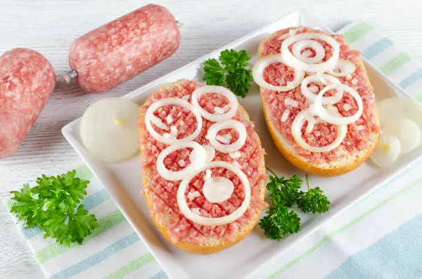 german food mett ground pork, raw meat with onion and parsley