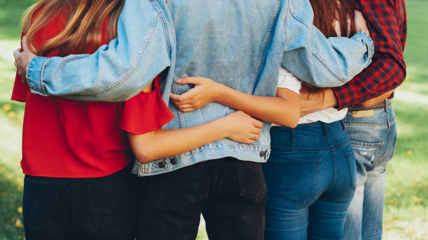 istock true friendship men women standing hugging park 1181879227