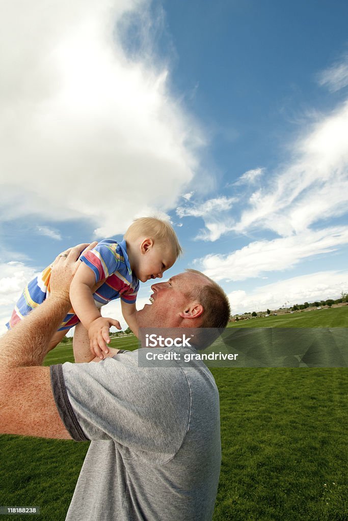 Toddler and Dad Cute toddler boy playing in the arms of his father Baby - Human Age Stock Photo