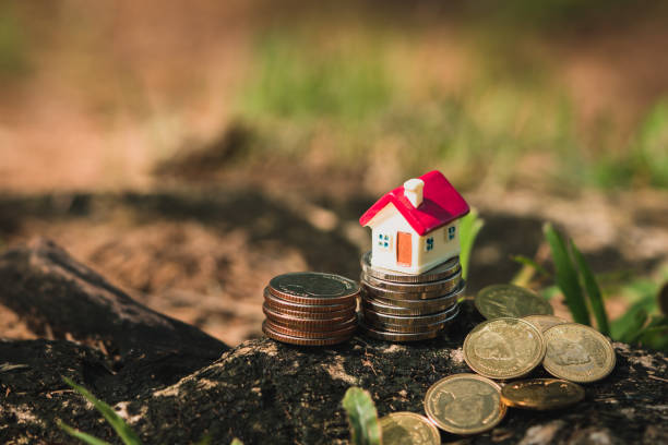 istock High angle view of miniature red house on stack coins 1181887166