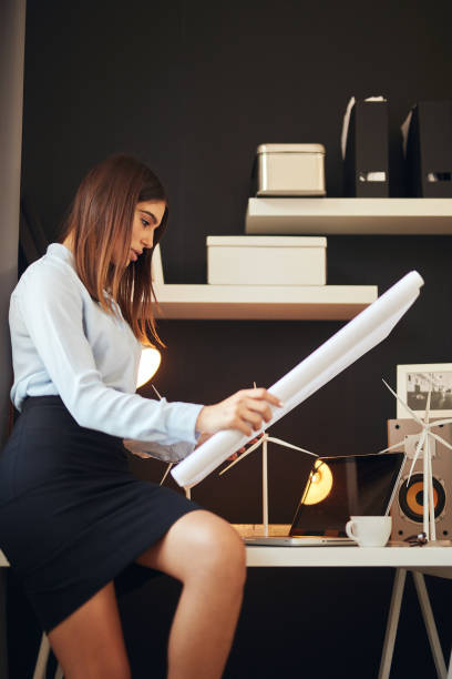 istock Businesswoman looking at plans. 1181888032