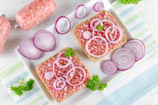 german food mett ground pork, raw meat with onion and parsley