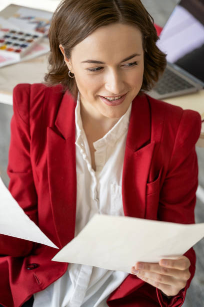 istock Happy stylish pretty lady holding her sketches 1181891613