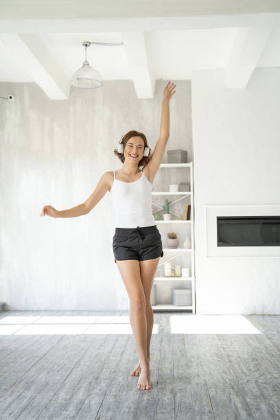 istock Joyful attractive young lady dancing to music 1181891705