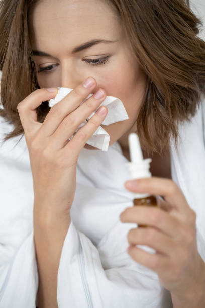 istock Low-spirited ill young female with a handkerchief 1181891746