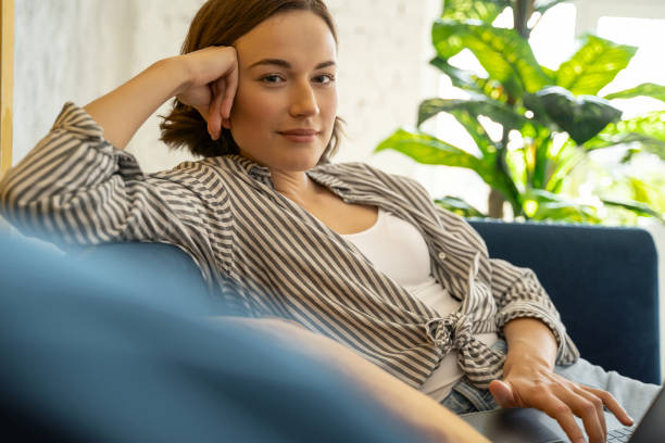 istock Cute calm young woman with a laptop 1181891843