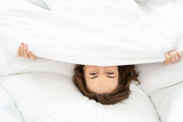 istock Female covering her face with a blanket 1181892019