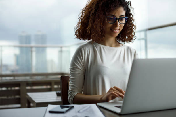 istock Young woman using laptop at a cafe 1181892828