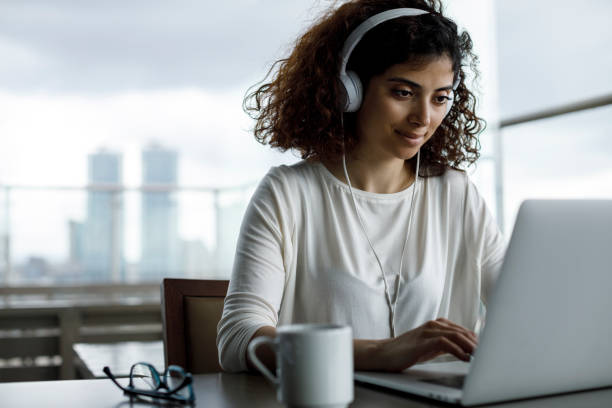 istock Smiling young freelancer girl working at a cafe 1181893046