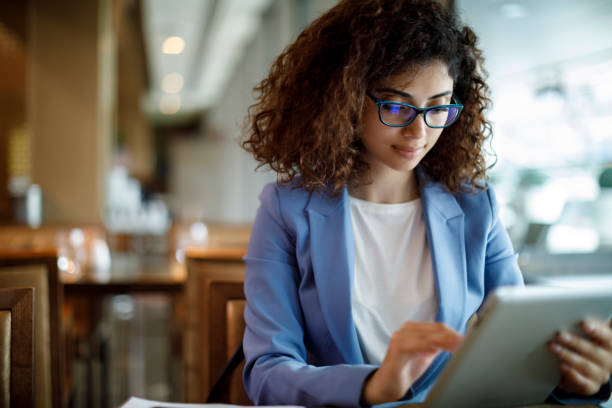 istock Businesswoman using digital tablet at a cafe 1181893059