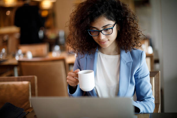 istock Young businesswoman using laptop in the restaurant 1181893061