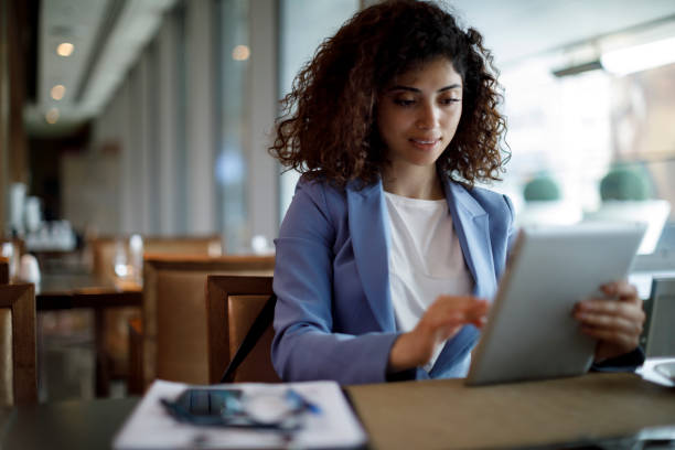 istock Businesswoman using digital tablet at a cafe 1181893133