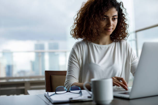 Young woman using laptop at a cafe
