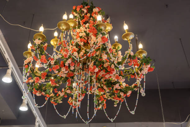 Chandelier decorated with artificial flowers and beads in a Chinese cafe