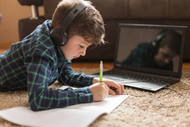 istock Boy with headphones writing 1181894301
