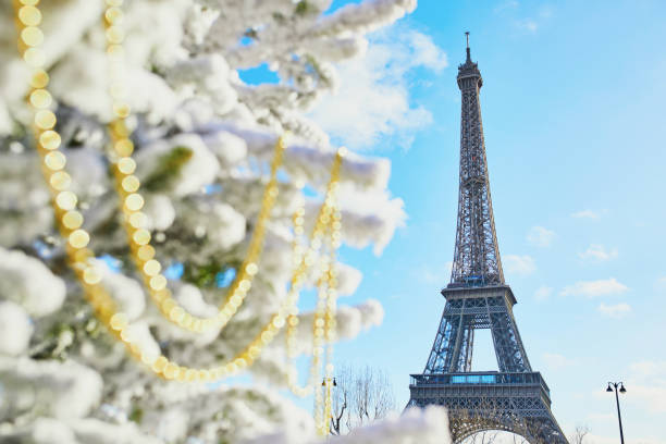 istock Christmas tree covered with snow near the Eiffel tower 1181895824